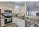 Well-equipped kitchen with granite countertops, stainless steel appliances, and ample cabinet space at 7930 W Colter St, Glendale, AZ 85303