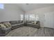 Bright living room with a high ceiling, neutral paint, hardwood flooring, and a comfortable gray sofa at 7930 W Colter St, Glendale, AZ 85303