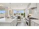 Elegant dining area with a chandelier, large windows, and a view of the backyard at 8012 W Griswold Rd, Peoria, AZ 85345