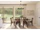 Cozy dining room with sliding glass doors, a modern light fixture, and seating for six at 8041 W Griswold Rd, Peoria, AZ 85345
