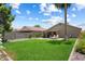 Spacious backyard featuring a well-manicured lawn, patio, and lush landscaping, offering a serene outdoor space at 810 E Potter Dr, Phoenix, AZ 85024