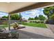 Inviting backyard featuring a covered patio, lush lawn, and comfortable lounge chairs at 810 E Potter Dr, Phoenix, AZ 85024
