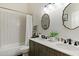 Bright bathroom with double sinks, stylish mirrors, and a shower-tub combination at 810 E Potter Dr, Phoenix, AZ 85024