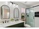 Modern bathroom features double sinks, a glass-enclosed shower with matte black hardware, and tasteful decor at 810 E Potter Dr, Phoenix, AZ 85024
