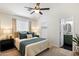 Comfortable bedroom featuring a ceiling fan, a neutral color scheme, and an en-suite bathroom at 810 E Potter Dr, Phoenix, AZ 85024