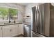 Bright, modern kitchen featuring white cabinets, stainless steel appliances, and a sleek marble backsplash at 810 E Potter Dr, Phoenix, AZ 85024