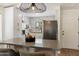 Eat-in kitchen with white cabinets, stainless steel appliances, and a modern island with bar seating at 810 E Potter Dr, Phoenix, AZ 85024