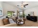 Cozy living room bathed in natural light features vaulted ceilings, a ceiling fan, and a comfortable sectional sofa at 810 E Potter Dr, Phoenix, AZ 85024