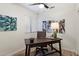 Home office featuring a large wooden desk, chair, artwork, and natural lighting at 810 E Potter Dr, Phoenix, AZ 85024