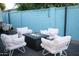 A cozy backyard setting with cushioned chairs and a modern fire pit at 8102 E Cambridge Ave, Scottsdale, AZ 85257
