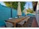 A large outdoor dining table beneath umbrellas, perfect for entertaining guests at 8102 E Cambridge Ave, Scottsdale, AZ 85257