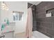 Stylish bathroom featuring a shower/tub, vanity, marble countertop, ample lighting, and a window offering natural light at 8102 E Cambridge Ave, Scottsdale, AZ 85257