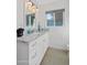 Bright bathroom featuring a marble countertop, ample lighting, and a window offering natural light in a serene atmosphere at 8102 E Cambridge Ave, Scottsdale, AZ 85257