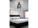 Modern bedroom features king-sized bed, stylish lighting, decor, hardwood floors, and natural light creating a relaxing space at 8102 E Cambridge Ave, Scottsdale, AZ 85257