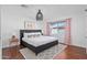 Inviting bedroom features king-sized bed, stylish lighting, decor, hardwood floors, and natural light creating a relaxing space at 8102 E Cambridge Ave, Scottsdale, AZ 85257