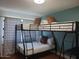 Cozy bedroom features a black metal bunk bed with comfortable mattresses and brown accent pillows at 8102 E Cambridge Ave, Scottsdale, AZ 85257