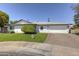 Charming single-story home with a well-manicured lawn and a two-car garage at 8102 E Cambridge Ave, Scottsdale, AZ 85257