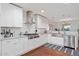 Bright kitchen with white cabinets, stainless appliances, subway tile backsplash, and hardwood floors at 8102 E Cambridge Ave, Scottsdale, AZ 85257