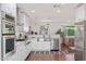 Well-equipped kitchen featuring stainless steel appliances, white cabinetry, and a view of the adjacent living area, designed for cooking at 8102 E Cambridge Ave, Scottsdale, AZ 85257