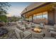 Relaxing back patio with an outdoor kitchen, a fire pit, and comfortable seating at 8154 E Tecolote Cir, Scottsdale, AZ 85266