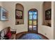 Inviting foyer with decorative tile flooring, arched doorway, and bench seating at 8154 E Tecolote Cir, Scottsdale, AZ 85266