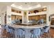 Stylish kitchen featuring a large curved island with seating, custom cabinets and modern appliances at 8154 E Tecolote Cir, Scottsdale, AZ 85266