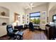 Bright office with a large window, built-in shelves, and comfortable seating at 8154 E Tecolote Cir, Scottsdale, AZ 85266