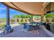 Covered patio with outdoor dining and seating, overlooking the pool and landscaped backyard at 8154 E Tecolote Cir, Scottsdale, AZ 85266