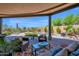 Covered patio featuring an outdoor lounge area with a view of the pool and desert landscape at 8154 E Tecolote Cir, Scottsdale, AZ 85266