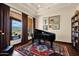 Cozy music room with a grand piano, hardwood floors, and large windows with a scenic view at 8154 E Tecolote Cir, Scottsdale, AZ 85266