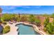 Backyard view featuring a sparkling pool, desert landscaping, and stunning mountain views at 8154 E Tecolote Cir, Scottsdale, AZ 85266