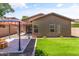 The backyard features artificial turf, desert landscaping and a covered patio with a gazebo at 838 W Basswood Ave, Queen Creek, AZ 85140