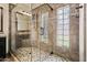 Bathroom features seamless glass shower and mosaic tiled flooring at 838 W Basswood Ave, Queen Creek, AZ 85140