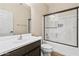 Bathroom boasts a shower over tub, vanity with dark wood cabinet, and chrome hardware at 838 W Basswood Ave, Queen Creek, AZ 85140