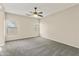 The spacious bedroom offers neutral walls, carpeting, a ceiling fan, and windows at 838 W Basswood Ave, Queen Creek, AZ 85140