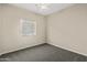 This bedroom offers neutral walls, carpeting, ceiling fan, and a window at 838 W Basswood Ave, Queen Creek, AZ 85140