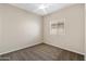 Bedroom features neutral carpeting, a ceiling fan, and a large window at 838 W Basswood Ave, Queen Creek, AZ 85140