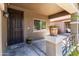 Covered front porch with flower pots and secure door for added privacy and curb appeal at 838 W Basswood Ave, Queen Creek, AZ 85140