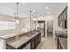 Open-concept kitchen featuring granite countertops, stainless steel appliances, and a breakfast bar at 838 W Basswood Ave, Queen Creek, AZ 85140