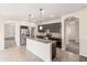 Modern kitchen features an island, stainless steel appliances, and sleek dark wood cabinetry at 838 W Basswood Ave, Queen Creek, AZ 85140