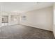 Spacious living room with gray carpet and ample natural light from large windows at 838 W Basswood Ave, Queen Creek, AZ 85140