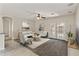 Well-lit living room with neutral tones, plush seating, and access to outdoor space at 838 W Basswood Ave, Queen Creek, AZ 85140