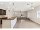 Open concept living room with tile flooring and a modern kitchen island with stone countertops at 838 W Basswood Ave, Queen Creek, AZ 85140