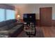 Cozy living room featuring a large television, plush seating, and ample natural light at 8600 E Broadway Rd # 91, Mesa, AZ 85208