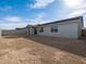 Exterior view of the home and backyard with block wall at 8634 W Albeniz Pl, Tolleson, AZ 85353