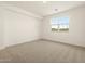 Bright bedroom featuring plush carpet, a large window, and fresh white walls that create a serene retreat at 8634 W Albeniz Pl, Tolleson, AZ 85353