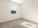 Clean, carpeted bedroom with a bright window and neutral walls at 8634 W Albeniz Pl, Tolleson, AZ 85353