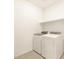 Laundry room featuring brand new washer and dryer and white shelving at 8634 W Albeniz Pl, Tolleson, AZ 85353