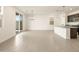 Bright, open living space showcases neutral tile, recessed lighting, and seamless flow to kitchen, perfect for entertaining at 8634 W Albeniz Pl, Tolleson, AZ 85353