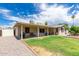 Expansive backyard boasts a covered patio, lush lawn, and desert landscaping perfect for outdoor living at 903 W Shawnee Dr, Chandler, AZ 85225